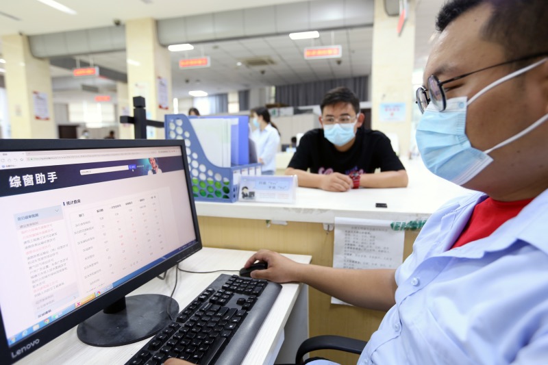 窗口服務人員利用“綜窗助手”開展服務。吳毅攝