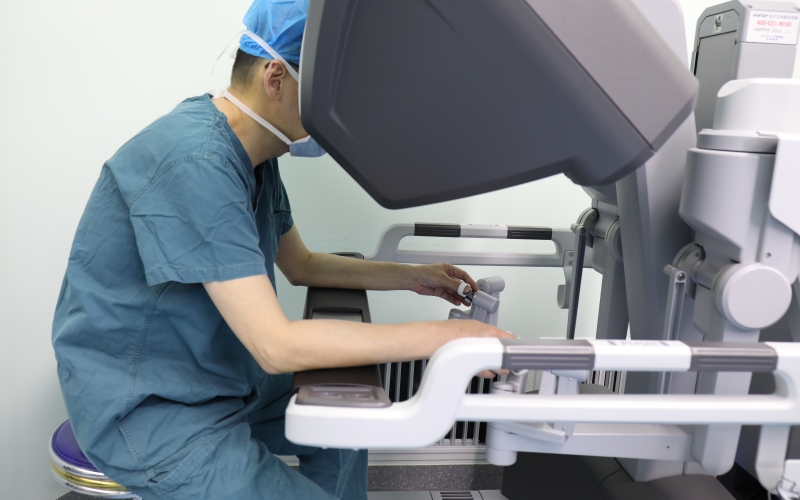 主刀醫(yī)師通過(guò)控制臺(tái)操作機(jī)器人進(jìn)行手術(shù)。代雨朦攝