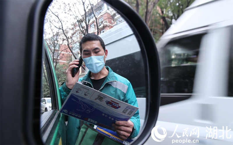  魯巷攬投站攬投員何亞飛電話聯(lián)系用戶預(yù)約投遞時(shí)間。人民網(wǎng) 肖璐欣攝