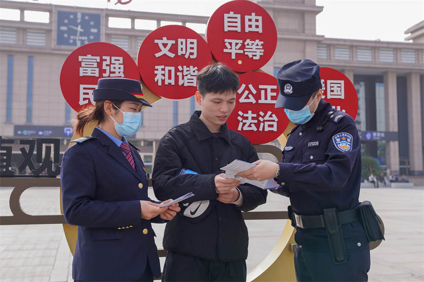 工作人員為過往旅客普及國家安全知識。李濤攝