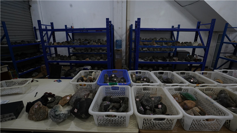 當(dāng)民警突入窩點(diǎn)時(shí)，10多個(gè)直播間正在熱火朝天的直播叫賣，架子上還擺放著各種所謂的翡翠原石。