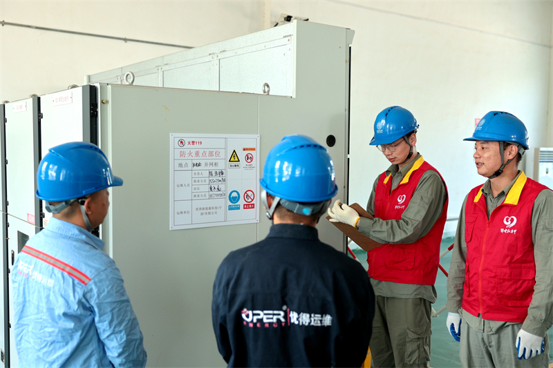 國(guó)網(wǎng)鄂州供電公司“鄂電紅馬甲”在唯品會(huì)物流園配電室內(nèi)檢查用電設(shè)備，確?！彪p11”物流園區(qū)可靠供電。戴佩攝