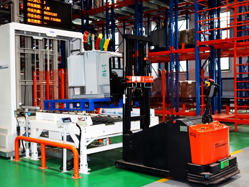 在國網(wǎng)武漢供電公司“檢儲(chǔ)配”一體化基地，智能叉車正將檢驗(yàn)合格的變壓器送往智能貨架。袁燁攝