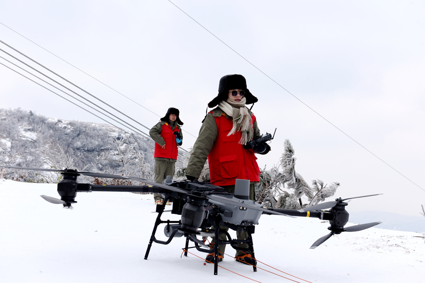 500千伏孝浉一二回線女飛手用重載無(wú)人機(jī)掛載自垂式震動(dòng)除冰裝置。鄒小民攝