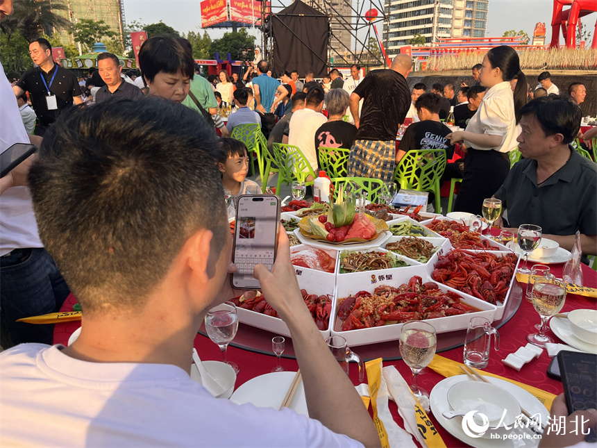享受全蝦宴的食客先拍照發(fā)朋友圈。人民網(wǎng)記者 張雋攝