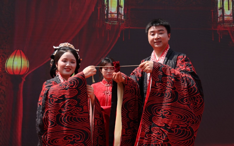 新人共同拓印婚書，體驗傳統(tǒng)文化。