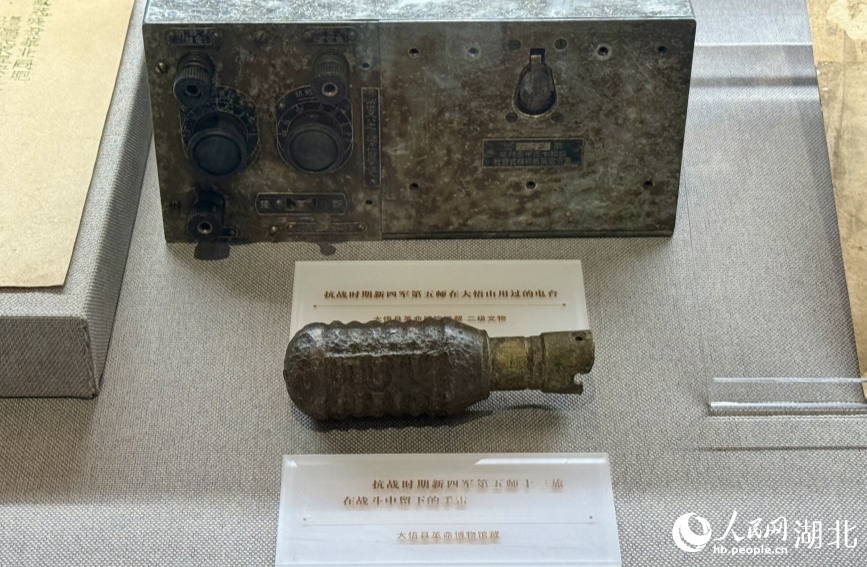 抗戰(zhàn)時(shí)期新四軍用過的電臺(tái)以及在戰(zhàn)斗中留下的手雷。人民網(wǎng)記者 周恬攝